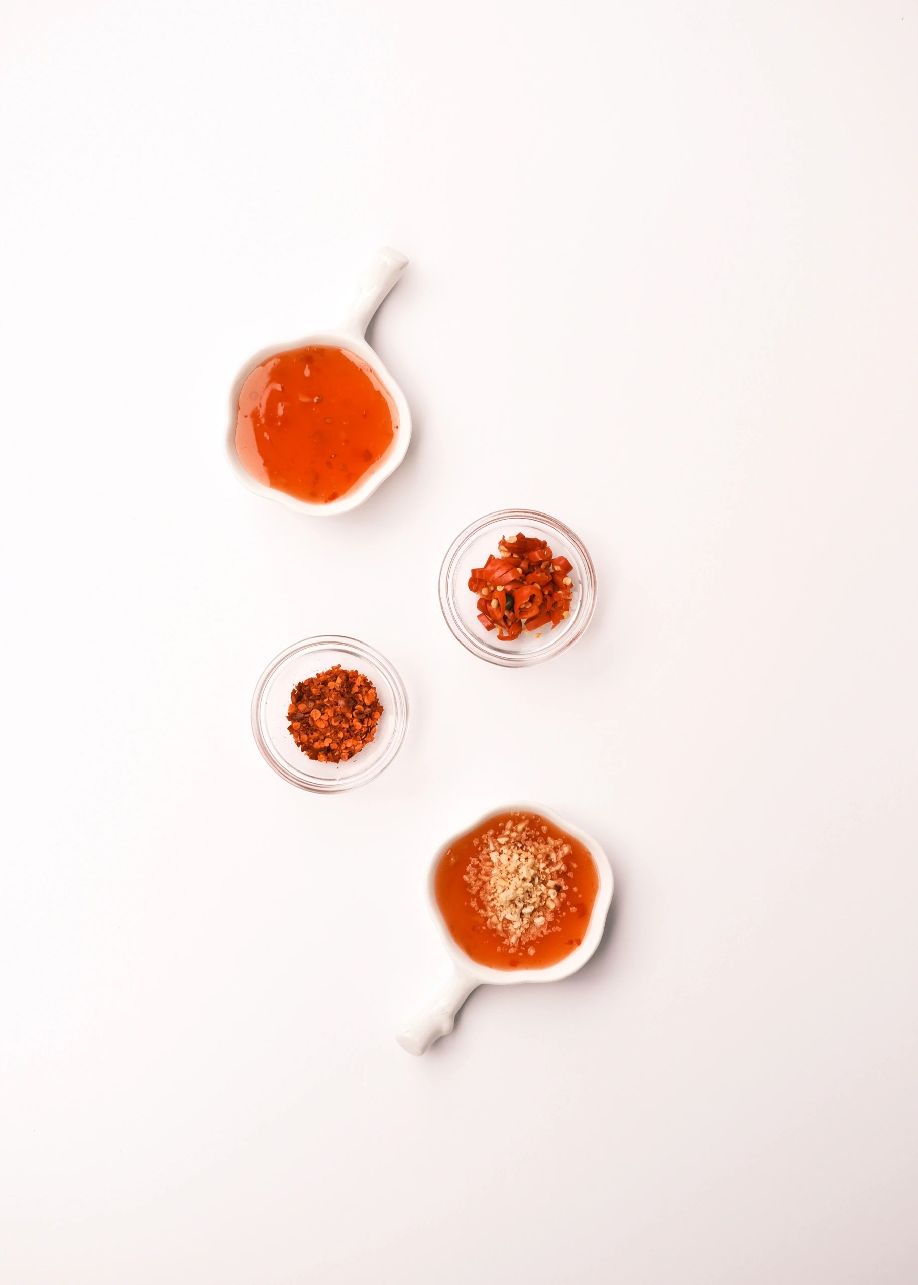 sauces in bowls on white background